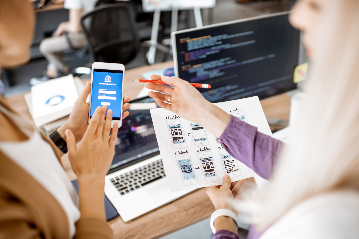 Product designers collaborate with software engineers on a project